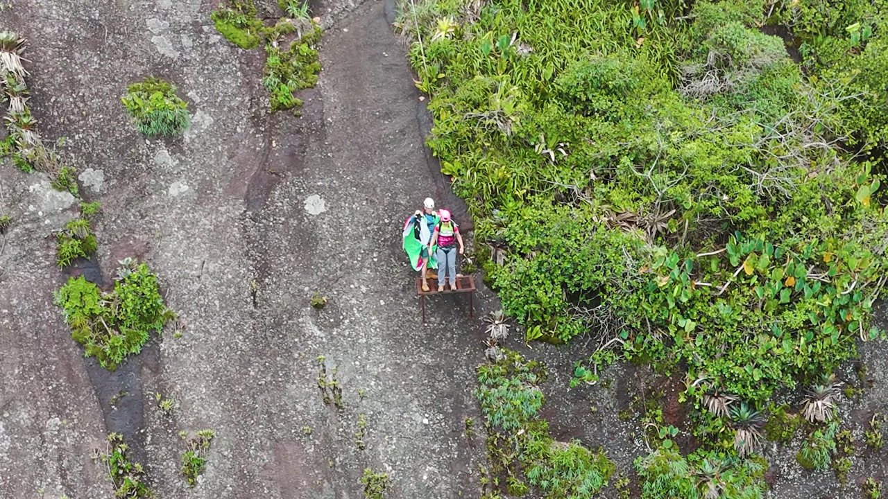 Two climbers on the granite slab with haul bags